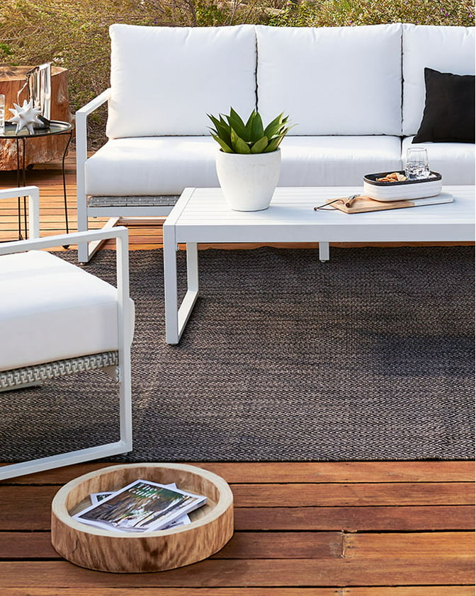 A modern white outdoor conversation set on a wooden patio. Links to patio furniture on usbigdeals.com.